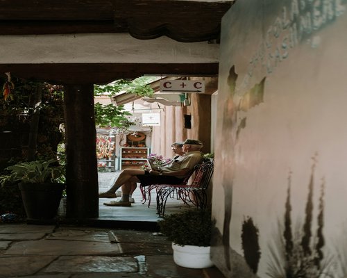 A person typing on a laptop with comfortable posture at a cafe in Mexico
