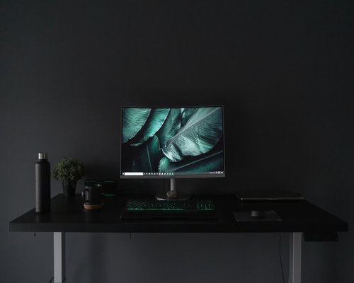 A clean desk setup showing monitor height and indirect lighting